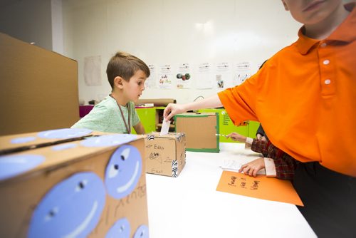 Henry McCrae-Kreider, 8, oversees the voting process at the Kids Can Vote election, which includes categories like Winnipeg's best pizza and sport teams as well as federal candidates, at Art City in Winnipeg on Friday, Oct. 2, 2015.  (Mikaela MacKenzie/Winnipeg Free Press)