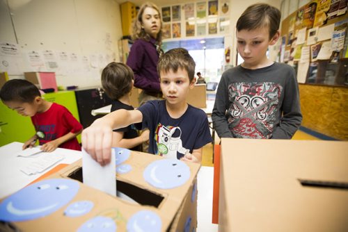 Sloan Fraser, 7, votes at the Kids Can Vote election, which includes categories like Winnipeg's best pizza and sport teams as well as federal candidates, at Art City in Winnipeg on Friday, Oct. 2, 2015.  (Mikaela MacKenzie/Winnipeg Free Press)