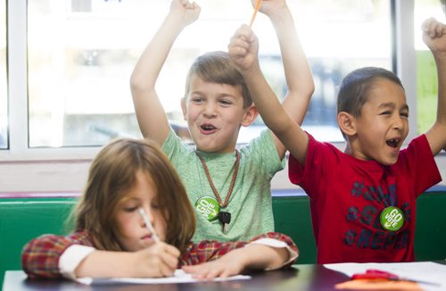 Gwyn Lewis (left), Henry McCrae-Kreider, and Edris Sajadi get excited at the Kids Can Vote election, which includes categories like Winnipeg's best pizza and sport teams as well as federal candidates, at Art City in Winnipeg on Friday, Oct. 2, 2015.  (Mikaela MacKenzie/Winnipeg Free Press)