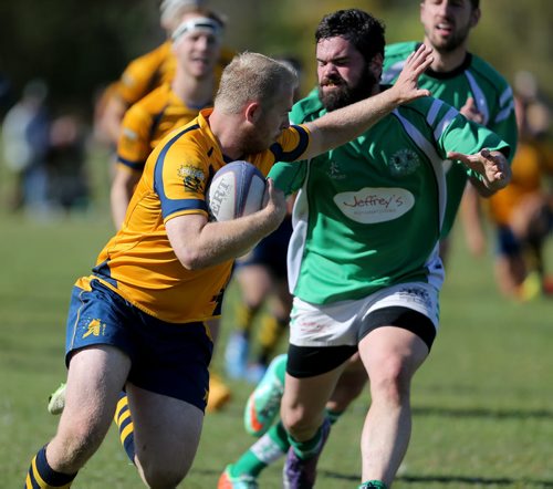 A player from the Winnipeg Saracens carries the ball past a member of the Wanderers during their finals game at Maple Grove Rugby Park, Saturday, October 3, 2015. (TREVOR HAGAN/WINNIPEG FREE PRESS)