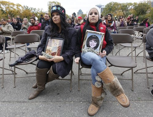 October 4, 2015 - 151004  - Gerri Pangman (L) with daughter  Corley McPherson hold photos of their sister and aunts Jennifer Johnston (L) and Jennifer Dawn McPherson at a gathering at the Manitoba legislature Sunday, October 4, 2015. The event is part of a  National  Day of Action for Violence Against Indigenous Women and taking place in various cities today. John Woods / Winnipeg Free Press