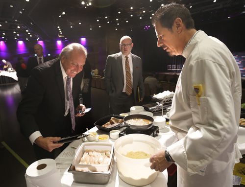 At left, Ron Lemieux, Minister Responsible for Manitoba Liquor and Lotteries checks out the pickerel that Chef Thomas Pitt is about to prepare at the announcement that Club Regent Casino and the McPhillips Station Casino will be serving certified sustainable Manitoba harvested pickerel. In back is John Stinson, CEO Manitoba Liquor & Lotteries. The event was held Monday at the Club Regent Casino.    Alex Paul story  Wayne Glowacki / Winnipeg Free Press October 5 2015
