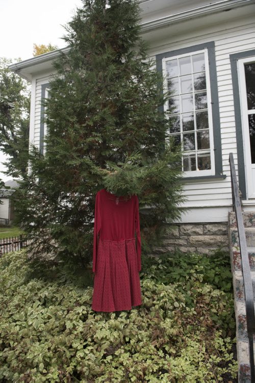 DAVID LIPNOWSKI / WINNIPEG FREE PRESS 151004  Red dresses hang in the Wolseley area as seen Sunday October 4, 2015. Artist Jaime Black has a callout for women to wear red dresses today, or hang them outside their houses as part of her MMIW redress project.