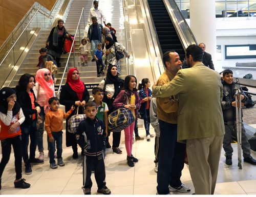 24 Syrians arrived at the  James A Richardson International Airport Monday afternoon and were greeted by family and volunteers. At right in sports jacket is Farid Abdullah embraces his brother-in-law Jalal who just arrived. The refugees have been living in a refugee camp for more than a year and were privately sponsored to come to Canada.  Carol Sanders story  Wayne Glowacki / Winnipeg Free Press October 5 201