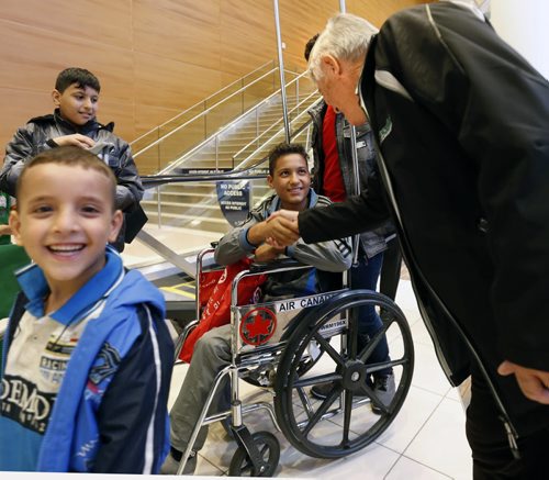 Omar,14, in the wheelchair is greeted as he arrives in Winnipeg. He was one of the 24 Syrians that arrived at James A Richardson International Airport Monday afternoon and were greeted by family and volunteers. They've been living in a refugee camp for more than a year and were privately sponsored to come to Canada.  Carol Sanders story  Wayne Glowacki / Winnipeg Free Press October 5 2015