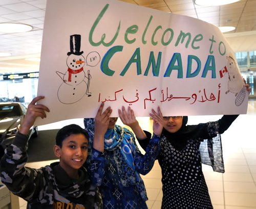 From left, Mohammed Abdullah with his sisters Sham and Riham wait anxously for their extended family to arrive that are part of the 24 Syrians to arrive at James A Richardson International Airport Monday afternoon. The refugees have been living in a refugee camp for more than a year and were privately sponsored to come to Canada.  Carol Sanders story  Wayne Glowacki / Winnipeg Free Press October 5 2015