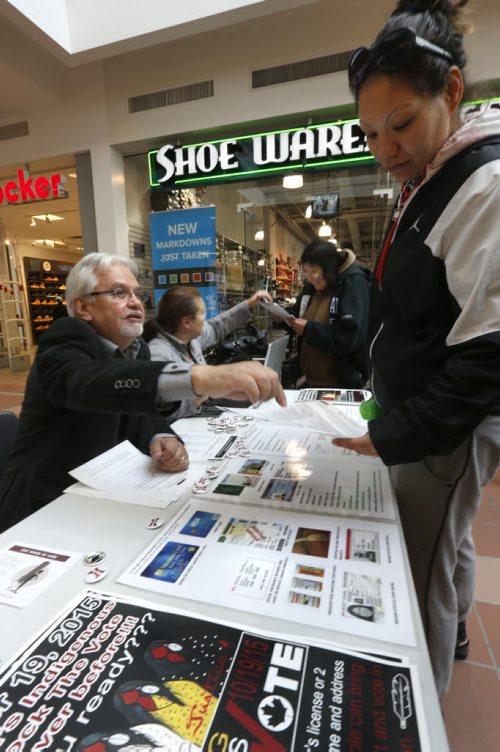 At left, Wayne and wife Della Mason answer voting questions from passerbys at the Winnipeg Indigenous Rock the Vote table set up Tuesday at Portage Place.    Kristin Annable story  Wayne Glowacki / Winnipeg Free Press October 6 2015