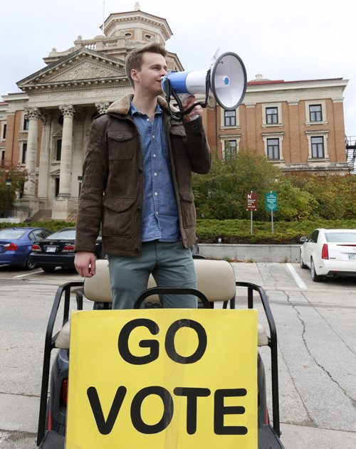 Jeremiah Kopp, president of the University of Manitoba Student Union using a megaphone driving around with a cart is encouraging students to vote at  the polling station at Pembina Hall Student Lounge on the campus. Jen Zoratti story on the youth vote..  Wayne Glowacki / Winnipeg Free Press October 8 2015