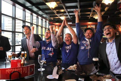 Toronto Blue Jays baseball fans celebrate after the Jays got a run in the 6th inning as they watch the game against Texas on TV at the Pint Thursday afternoon.   Names from left - Ross McFadyen (hat, suit jacket), Scott Hoeppner (glasses, jersey), Glen Agar (white hair, centre), Chris Stanton (hat, jersey, cape) and Sacha Paul (suit, far right). Oct 08, 2015 Ruth Bonneville / Winnipeg Free Press