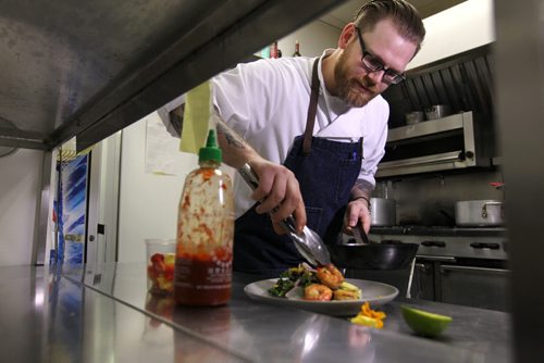 ENT - Food Front. Chef Sean McKay, plates a salad with a south-western flair topped with seared prawns in his kitchen at The Mitchell Block.  For story on a new cook book coming out this month with local chef's.   See Wendy King story.   Oct 09, 2015 Ruth Bonneville / Winnipeg Free Press