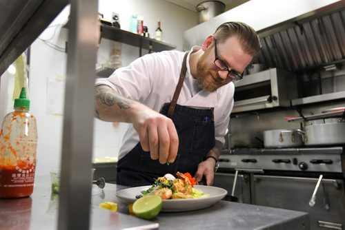 ENT - Food Front. Chef Sean McKay, plates a salad with a south-western flair topped with seared prawns in his kitchen at The Mitchell Block.  For story on a new cook book coming out this month with local chef's.   See Wendy King story.   Oct 09, 2015 Ruth Bonneville / Winnipeg Free Press