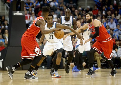 Chicago Bulls' Jimmy Butler dribbles the ball in front of  Minnesota Timberwolves' Andrew Wiggins and Kevin Garnett with Bulls' Nikola Mitotic nearby, during an exhibition game at MTS Centre, Saturday, October 10, 2015. (TREVOR HAGAN/WINNIPEG FREE PRESS)