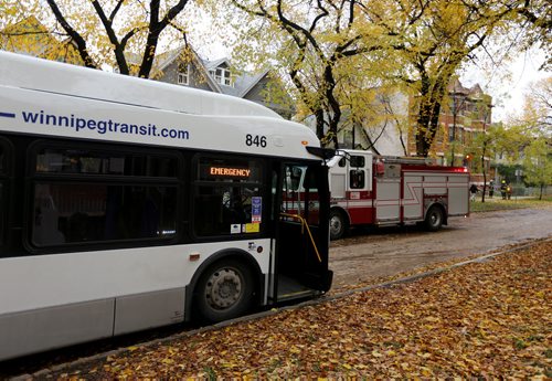 A city bus acts as a temporary shelter for residents evacuated from an apartment building on Spence Street, north of Ellice after a hydro pole was damaged behind the building, Monday, October 12, 2015. (TREVOR HAGAN/WINNIPEG FREE PRESS) for carol sanders story