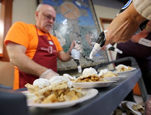 John Drew and other volunteers put whipped cream on pie during Thanksgiving at Siloam Mission, Monday, October 12, 2015. (TREVOR HAGAN/WINNIPEG FREE PRESS) for carol sanders story