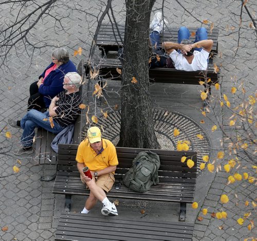 People sit at The Forks. For RIVER PROJECT Sunday, October 11, 2015. (TREVOR HAGAN/WINNIPEG FREE PRESS)