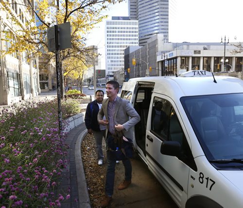 Uber Canada's Public Policy Manager Chris Schafer got a ride from taxi driver Nadeem Arain from the airport to the Winnipeg Chamber of Commerce office Wednesday morning. Martin Cash story.Wayne Glowacki / Winnipeg Free Press October 14 2015