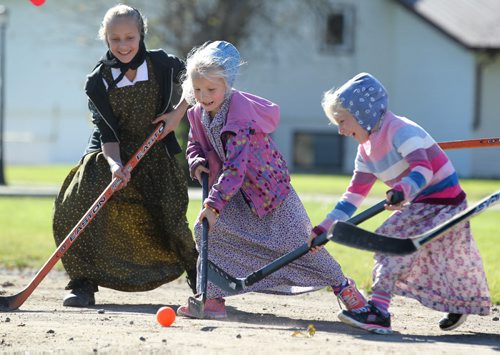Students from Emerald Hutterite Colony in The Pine Creek School Division play sponge hockey during recess on a warm, fall afternoon Tuesday.    Feature story on Pine Creek School Division's TMO teaching program (audio program)  for distance learning.  See Nick Martin's story.  Oct 13, 2015 Ruth Bonneville / Winnipeg Free Press