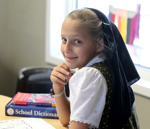 Photo of Jolene Waldner in a k - 8 class at Emerald Hutterite Colony.  Feature story on Pine Creek School Division's TMO teaching program (audio program) for distance learning.  See Nick Martin's story.  Oct 13, 2015 Ruth Bonneville / Winnipeg Free Press play