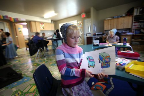 Photo of Crystal Waldner shows off her work while in a k - 8 class at Emerald Hutterite Colony.  Feature story on Pine Creek School Division's TMO teaching program (audio program) for distance learning.  See Nick Martin's story.  Oct 13, 2015 Ruth Bonneville / Winnipeg Free Press play