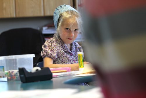Photo of Akyro Waldner works in her  k - 8 class at Emerald Hutterite Colony.  Feature story on Pine Creek School Division's TMO teaching program (audio program) for distance learning.  See Nick Martin's story.  Oct 13, 2015 Ruth Bonneville / Winnipeg Free Press play