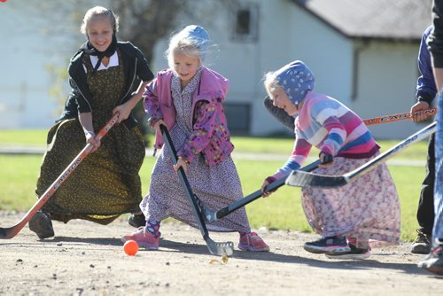 Students from Emerald Hutterite Colony in The Pine Creek School Division play sponge hockey during recess on a warm, fall afternoon Tuesday.    Feature story on Pine Creek School Division's TMO teaching program (audio program)  for distance learning.  See Nick Martin's story.  Oct 13, 2015 Ruth Bonneville / Winnipeg Free Press