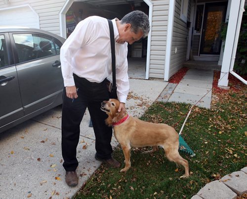 Dan Vandal campaign. Door to door in Southdale area.  Here he pets a dog on his tour. BORIS MINKEVICH / WINNIPEG FREE PRESS  OCT 14, 2015