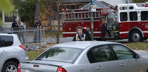 A Winnipeg Fire Paramedic approaches a distraught driver who was concerned her daughter was involved in the Thursday morning collision incident at the intersection of Manitoba Ave. and McNichol St.  Wayne Glowacki / Winnipeg Free Press October 15 2015