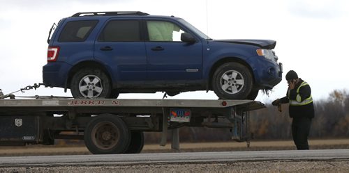 A damaged vehicle is towed away after a collision on Highway 213 (Garvin Rd.) at Dundee Garson Rd. 33E Thursday morning. The section of Hwy. 213 was closed during the investigation, it is now open. Wayne Glowacki / Winnipeg Free Press October 15 2015