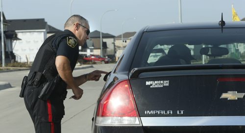 49.8  Winnipeg Police Const. Sal Signorino has a chat with a driver regarding the speed he was travelling on Concordia . The Const, was out monitoring speed drivers in a residential neighbourhood after resident's complaints of speeders. This is part of the Winnipeg Police Service East District Station Community Support Unit.  Kevin Rollason story on the SMART Policing Initiative (SPI).   Wayne Glowacki / Winnipeg Free Press October 9 2015