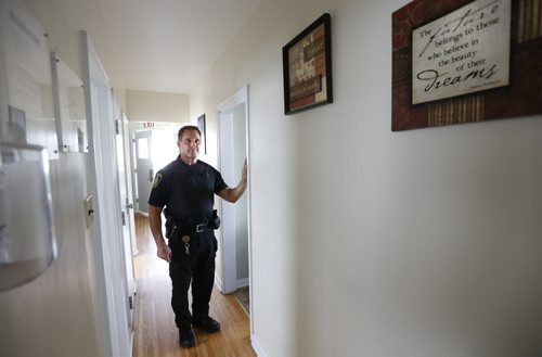 49.8  Winnipeg Police Const. Gerry Bernas works on crime prevention through social development. He is at a group home dropping off information for two youth residents.   This is part of the Winnipeg Police Service East District Station Community Support Unit.  Kevin Rollason story on the SMART Policing Initiative (SPI).   Wayne Glowacki / Winnipeg Free Press October 9 2015
