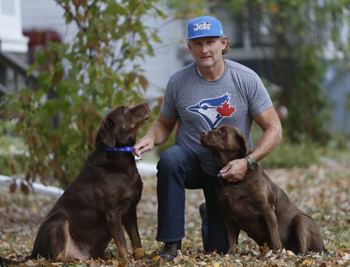 Curtis Starkell with his two chocolate Labs Lola,right, and Capone. For story on City hall is cracking down on its pet licensing.  Aldo Santin story.  Wayne Glowacki / Winnipeg Free Press October 16 2015