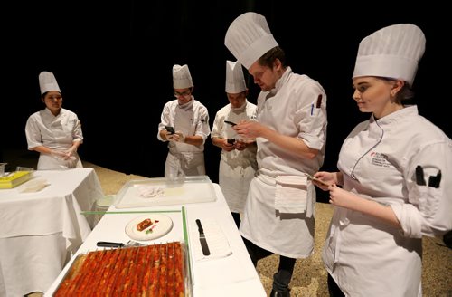 In the Yujiro display, workers for Chef Edward Lam, photographing his dish, foie gras lobster terrine, Gold Medal Plates competition at the Convention Centre, Friday, October 16, 2015. (TREVOR HAGAN/WINNIPEG FREE PRESS)