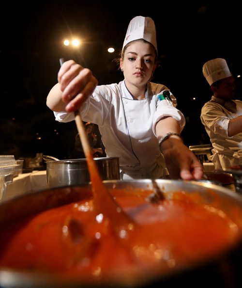 Anna MaDonald stirring stracotto for Chef Fabrizio Rossi, from Nicolinos, during the Gold Medal Plates competition at the Convention Centre, Friday, October 16, 2015. (TREVOR HAGAN/WINNIPEG FREE PRESS)