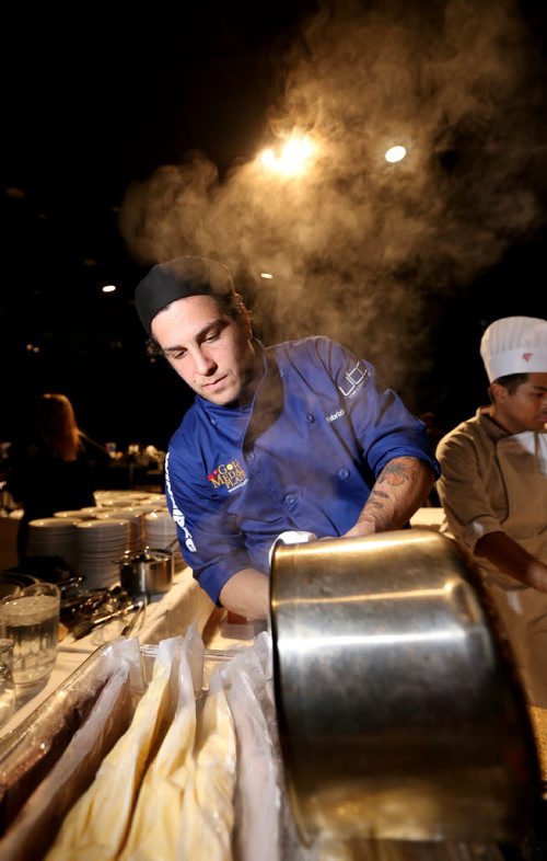 Chef Fabrizio Rossi, from Nicolinos, pouring hot water into a container of polenta, during the Gold Medal Plates competition at the Convention Centre, Friday, October 16, 2015. (TREVOR HAGAN/WINNIPEG FREE PRESS)