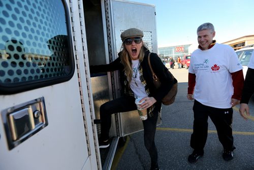 Actress Jes Macallan getting into a sheriff's truck during The Celebrity Human Race, an HSC Foundation fundraiser, Saturday, October 17, 2015. (TREVOR HAGAN/WINNIPEG FREE PRESS)