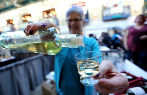 Marjorie Fortier, from Renaissance Wines pours a sample of wine during the International Wine Festival at The Forks, Saturday, October 17, 2015. (TREVOR HAGAN/WINNIPEG FREE PRESS)
