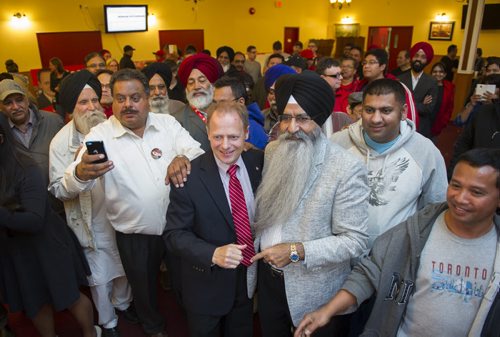 DAVID LIPNOWSKI / WINNIPEG FREE PRESS 151019  Incumbent Liberal Kevin Lamoureaux (red tie) joins supporters at the Punjab Banquet Hall in his Winnipeg North riding Monday October 19, 2015.