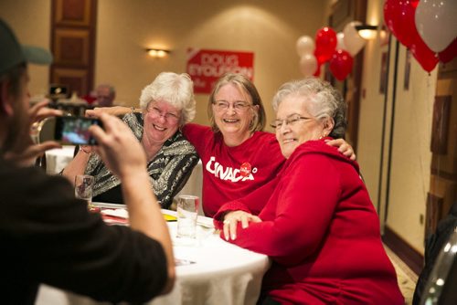 Liberal supporters Barb King (left), Margaret Semple, and Jeannette Metcalfe a celebrate Doug Eyolfson's win at a Holiday Inn in Winnipeg on Monday, Oct. 19, 2015.   (Mikaela MacKenzie/Winnipeg Free Press)
