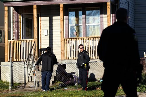 Police attend the scene of an apparent shooting at 262 Rietta Wednesday morning. One person is reported to have been taken by ambulance to the hospital.   See Bill Redekop for more info. Oct 21, 2015 Ruth Bonneville / Winnipeg Free Press pla