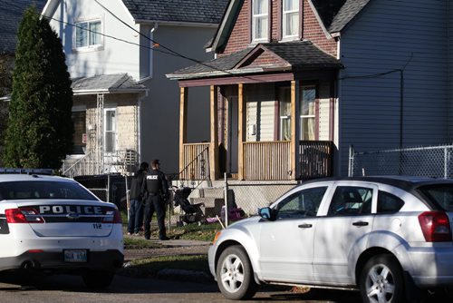 Police attend the scene of an apparent shooting at 262 Rietta Wednesday morning. One person is reported to have been taken by ambulance to the hospital.   See Bill Redekop for more info. Oct 21, 2015 Ruth Bonneville / Winnipeg Free Press pla