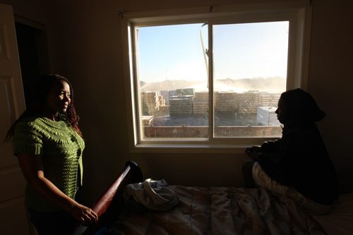 Mbawemi Nungo, 19 yrs, and his mother Grace Mbawemi  called 911 when he first saw the huge fire at Waverley St and Sandusky Dr that started early this morning in Winnipeg- Breaking News -Oct 22, 2015   (JOE BRYKSA / WINNIPEG FREE PRESS)