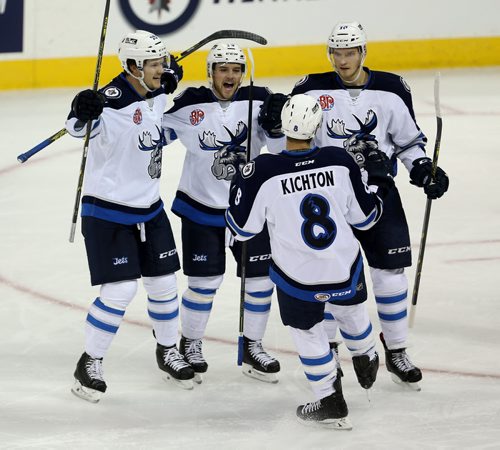 Manitoba Moose Matt Fraser (25),Chase De Leo (19), Brenden Kichton (8), and Joel Armia(10) celebrate after Armia opened the scoring against the Lake Erie Monsters during first period AHL hockey action, Thursday, October 22, 2015. (TREVOR HAGAN/WINNIPEG FREE PRESS)