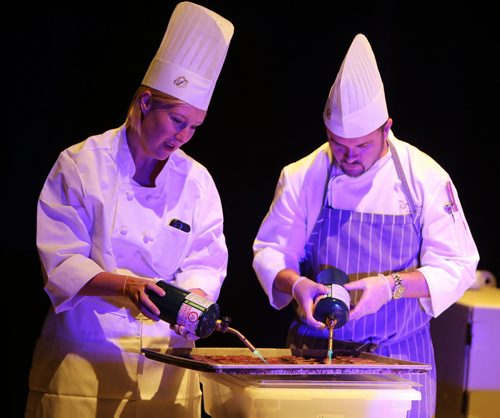 L-R: Marketing manager Pascale Rocher and sous chef Richard Duncan of the Velvet Glove restaurant prepare bison tataki at the Gold Medal Plates food and wine event at the RBC Convention Centre Winnipeg on Oct. 16, 2015. Photo by Jason Halstead/Winnipeg Free Press RE: Social Page for Oct. 24, 2015