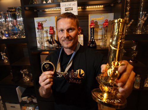 The former Olympic snowboarding gold medallist Ross Rebagliatiis in town promoting his medical marijuana company, Ross' Gold. Photographed at Aluminium Sound at 251 Vaughn. Here he holds his gold medal and a$24,000 bong. BORIS MINKEVICH / WINNIPEG FREE PRESS  OCT 23, 2015