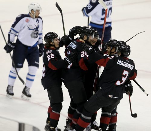 Lake Erie Monsters' Ryan Craig (12), middle, celebrates with his line after he scored on the Manitoba Moose during first period AHL hockey action at MTS Centre, Saturday, October 24, 2015. (TREVOR HAGAN/WINNIPEG FREE PRESS)