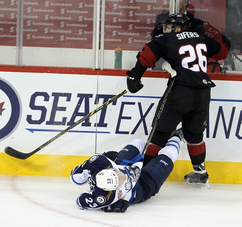Manitoba Moose Axel Blomqvist (23) gets the worst of a collision with Lake Erie Monsters' Jaime Sifers (26) during first period AHL hockey action at MTS Centre, Saturday, October 24, 2015. (TREVOR HAGAN/WINNIPEG FREE PRESS)