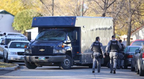 Winnipeg Police and the Tactical Unit begin to pack up after a standoff on Keenlyside Street, Sunday, October 25, 2015. (TREVOR HAGAN / WINNIPEG FREE PRESS)