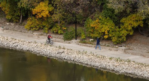 A pedestrian and cyclist make their way along the River Walk on the Assiniboine River. 150930 - Wednesday, September 30, 2015 -  MIKE DEAL / WINNIPEG FREE PRESS