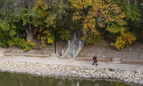 A pedestrian makes their way along the River Walk on the Assiniboine River. 150930 - Wednesday, September 30, 2015 -  MIKE DEAL / WINNIPEG FREE PRESS