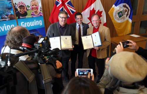 Mayor Brian Bowman, centre, presented the Community Service Award to CJOB Traffic reporter Brian Barkley, right, and Dancing Gabe Langlois, left, to acknowledge outstanding service to the community. Event took place in the Mayors Foyer, Second Floor, City Hall, 510 Main Street. BORIS MINKEVICH / WINNIPEG FREE PRESS  OCT 26, 2015